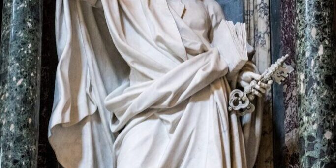 Marble statue of a bearded man holding keys.