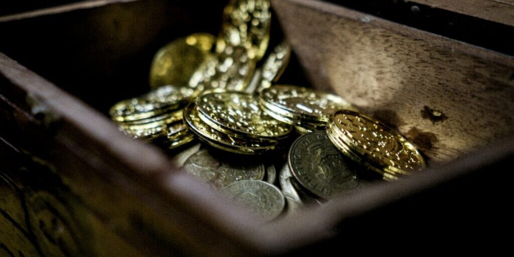 a wooden box filled with lots of coins