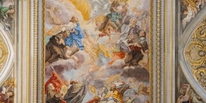 The ceiling of a building with a painting on it