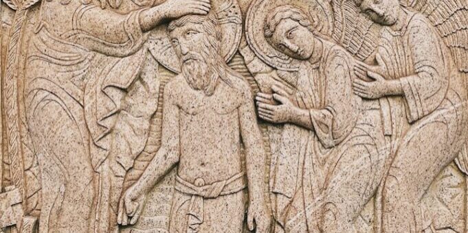 a carving of a group of people on a wall