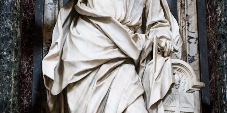 A marble statue of a man gesturing.